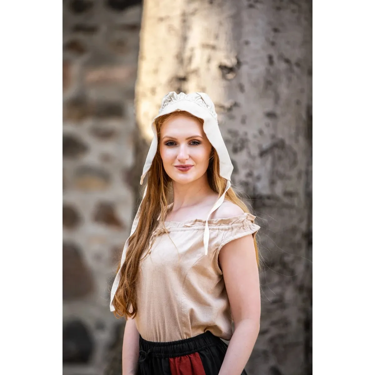 A woman wears a bonnet